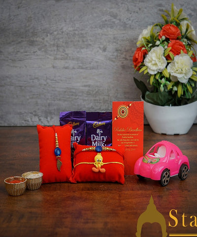 StatueStudio Rakhi Gift For Bhaiya Bhabhi & Kids With Rakshabhandhan Gift Hamper Combo - Toy Car Showpiece, 2 Pcs Rakhi, 2 Pcs Dairy Milk Chocolate, Roli Chawal & Designer Greeting Card