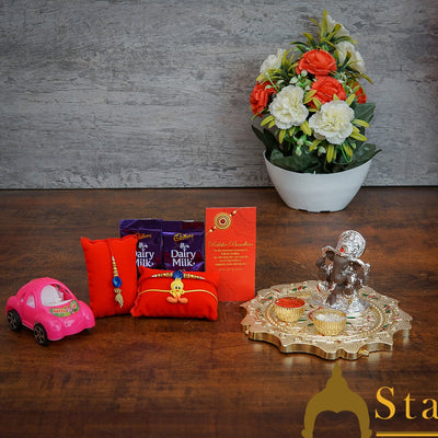StatueStudio Rakhi Gift For Bhaiya Bhabhi & Kids With Rakshabhandhan Gift Hamper Combo - Lumba Rakhi & Kids Rakhi, Kum Kum Dabbi, Greeting Card, 2 pcs Dairy Milk, Roli Chawal, Toy Car, Ganesha Statue