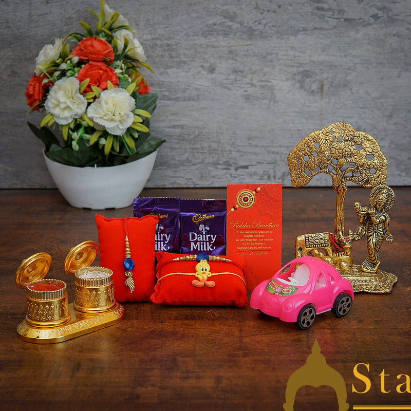 StatueStudio Rakhi Gift For Bhaiya Bhabhi & Kids With Rakshabhandhan Gift Hamper Combo - Lumba Rakhi & Kids Rakhi, Kum Kum Dabbi, Greeting Card, 2 pcs Dairy Milk, Roli Chawal, Toy Car, Metal krishna Tree Showpiece
