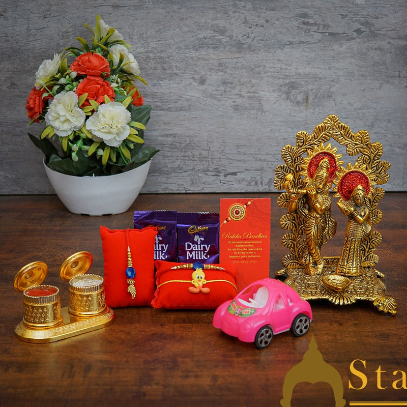 StatueStudio Rakhi Gift For Bhaiya Bhabhi & Kids With Rakshabhandhan Gift Hamper Combo - Lumba Rakhi & Kids Rakhi, Kum Kum Dabbi, Greeting Card, 2 pcs Dairy Milk, Roli Chawal, Toy Car, Metal Radha Krishna Showpiece