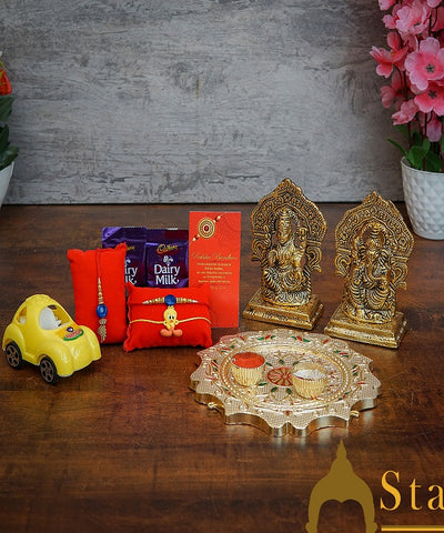 StatueStudio Rakhi Gift For Bhaiya Bhabhi & Kids With Rakshabhandhan Gift Hamper Combo - Lumba Rakhi & Kids Rakhi, Kum Kum Dabbi, Greeting Card, 2 pcs Dairy Milk, Roli Chawal, Toy Car, Pooja Thali & Metal Laxmi Ganesha Idol