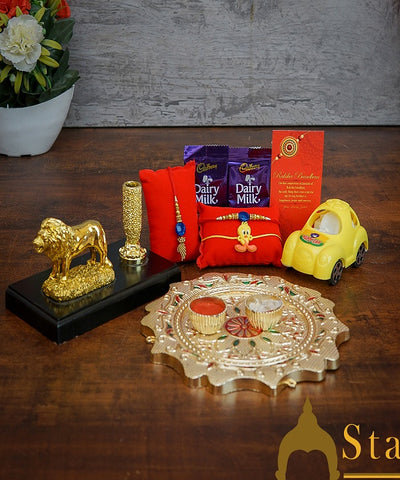 StatueStudio Rakhi Gift For Bhaiya Bhabhi & Kids With Rakshabhandhan Gift Hamper Combo - Lumba Rakhi & Kids Rakhi, Kum Kum Dabbi, Greeting Card, 2 pcs Dairy Milk, Roli Chawal, Toy Car, Pooja Thali & Lion Pen Stand